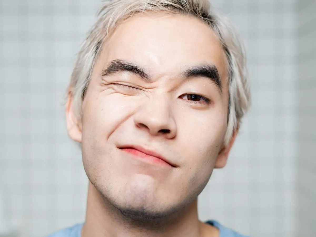 Young Filipino man with a playful expression, representing discussions on premature ejaculation and its common causes among Filipino men.